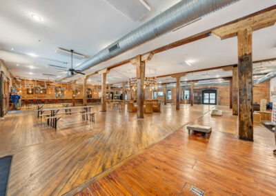 wide angle view of Ballad Brewing tasting room in historic warehouse building