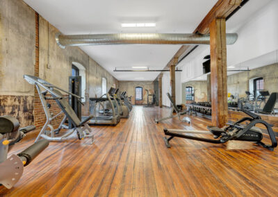 Long view of room with work out machines, located in historic renovated apartment building