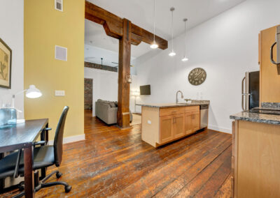 Staged apartment with original, historic wood beam in the center