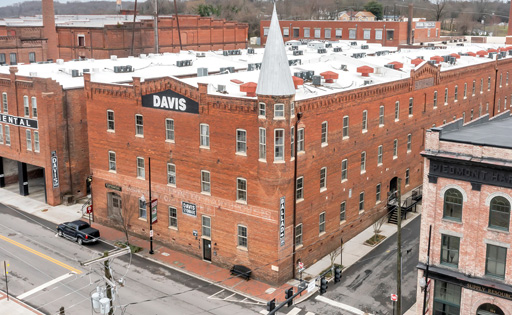3-story red brick warehouse building with corner tourette