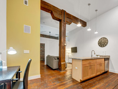 Interior detail bright apartment with exposed wooden beam in kitchen