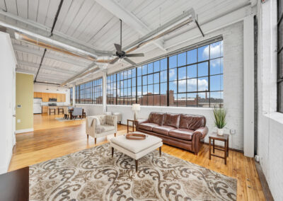 Apartment living room with high ceilings and large industrial windows