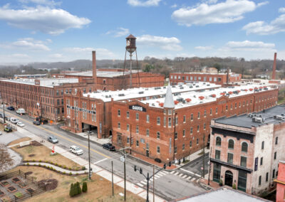 Street scape of four historic warehouse buildings taken from a high vantage point across the street
